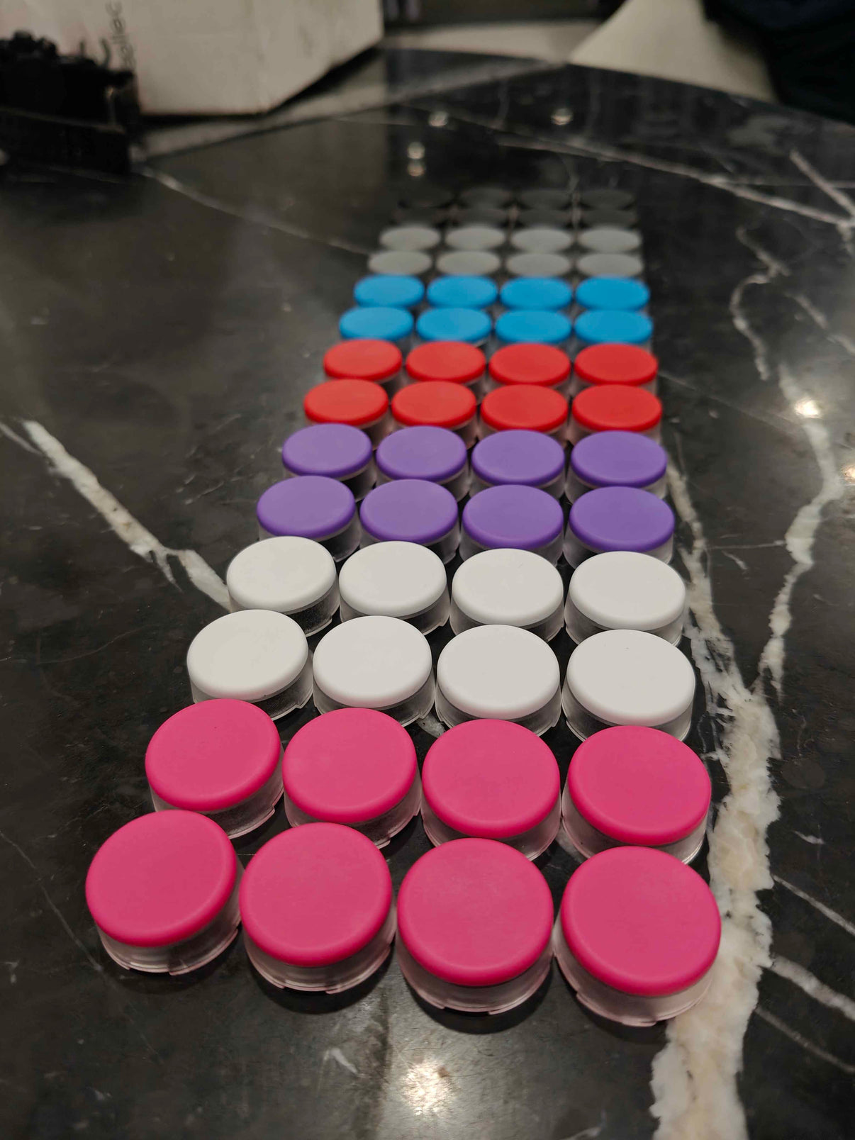 Rows of raised key caps in sets of 8 in various colors including white, blue, pink and orange.