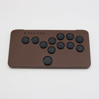 The chocolate brown one-piece case version of the SnackBox Micro from JunkFood Arcades.