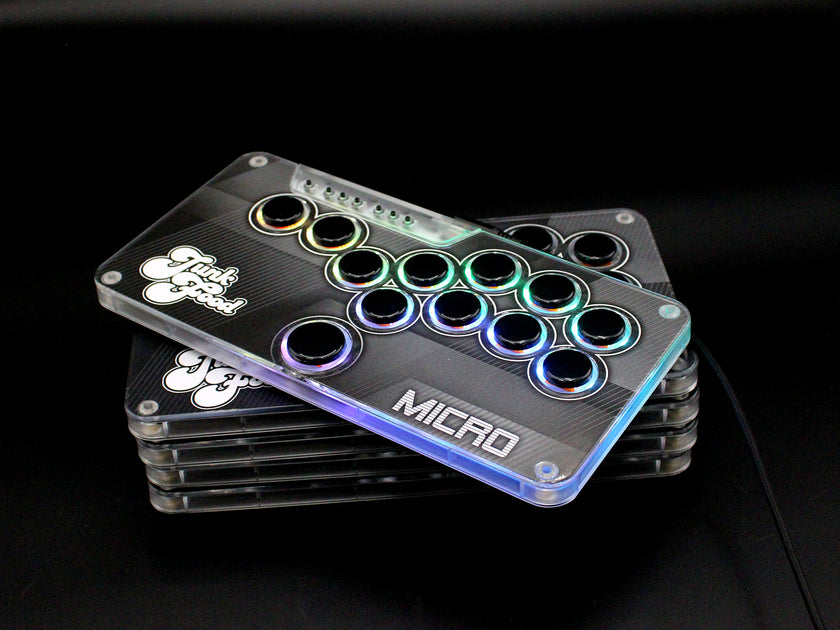 Five stacked Snack Box MICRO leverless FGC fight stick controllers with JunkFood artwork, alternate angle