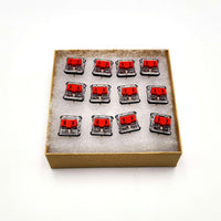 Set of 12 Kailh low-profile Choc red switches in a box for leverless FGC fight stick controllers like the Snack Box MICRO