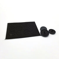 Set of 12 button silencing pads on a foam sheet beside three black keycaps for the Snack Box MICRO leverless FGC fight stick controller