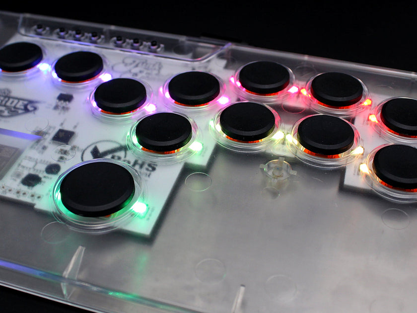 Close-up of the MICRO XL leverless FGC fight stick controller with clear top and RGB LEDs lit