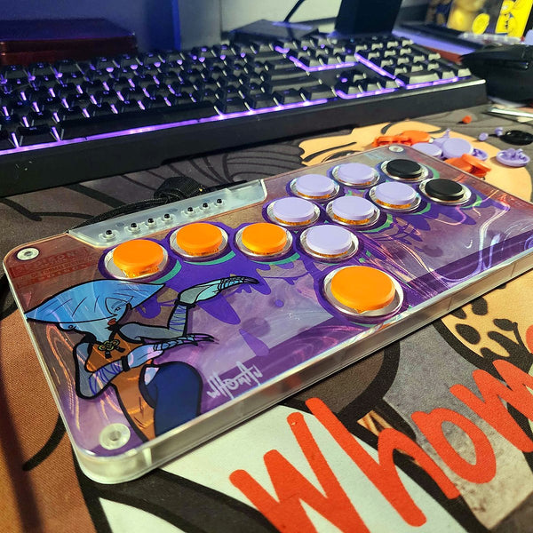 Snack Box MICRO with orange and lavender keycaps and custom art on a desk