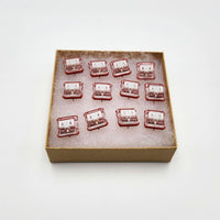 A set of 12 red pro Kailh switches in a box.