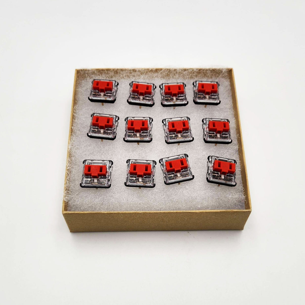 A set of 12 red Kailh switches in a box.